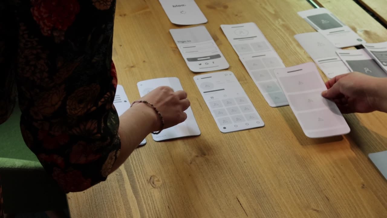 Paper wireframes laid out on a table